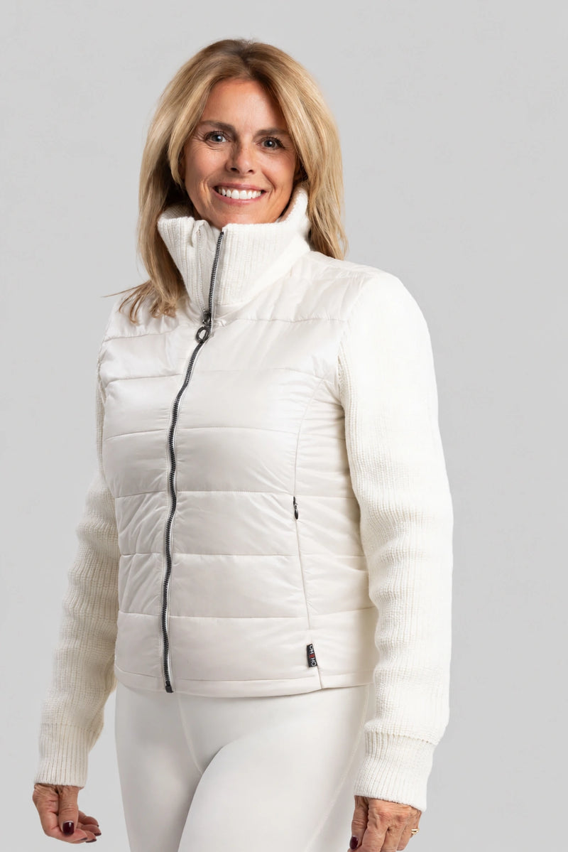 Woman wearing a white puffer jacket on a gray background