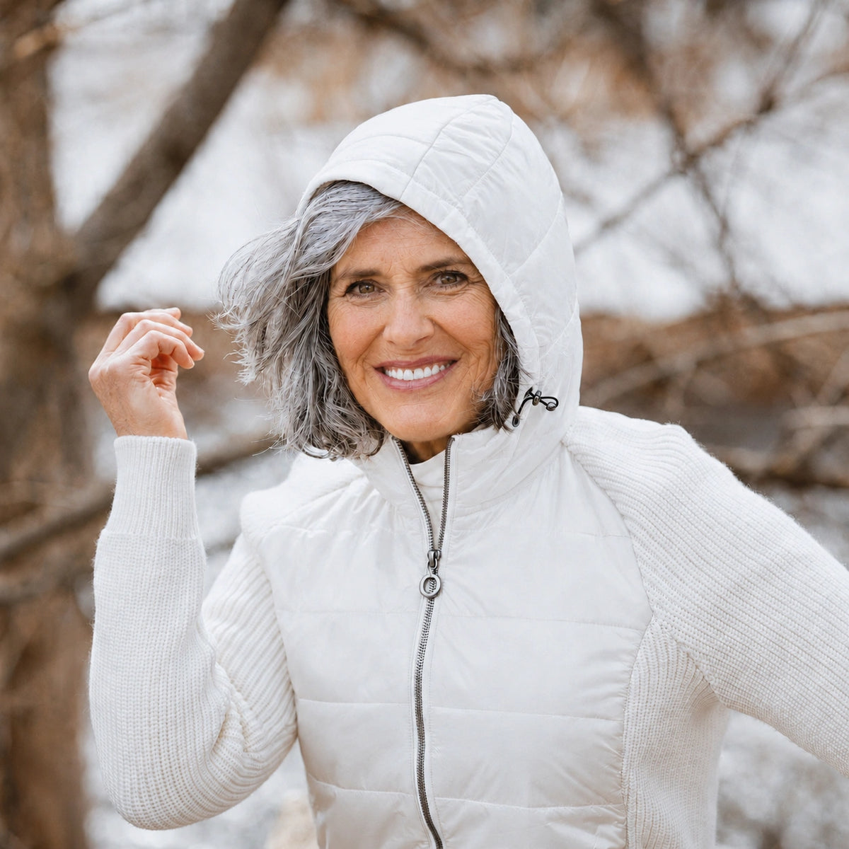 Woman wearing a white puffer jacket in a snowy outdoor setting